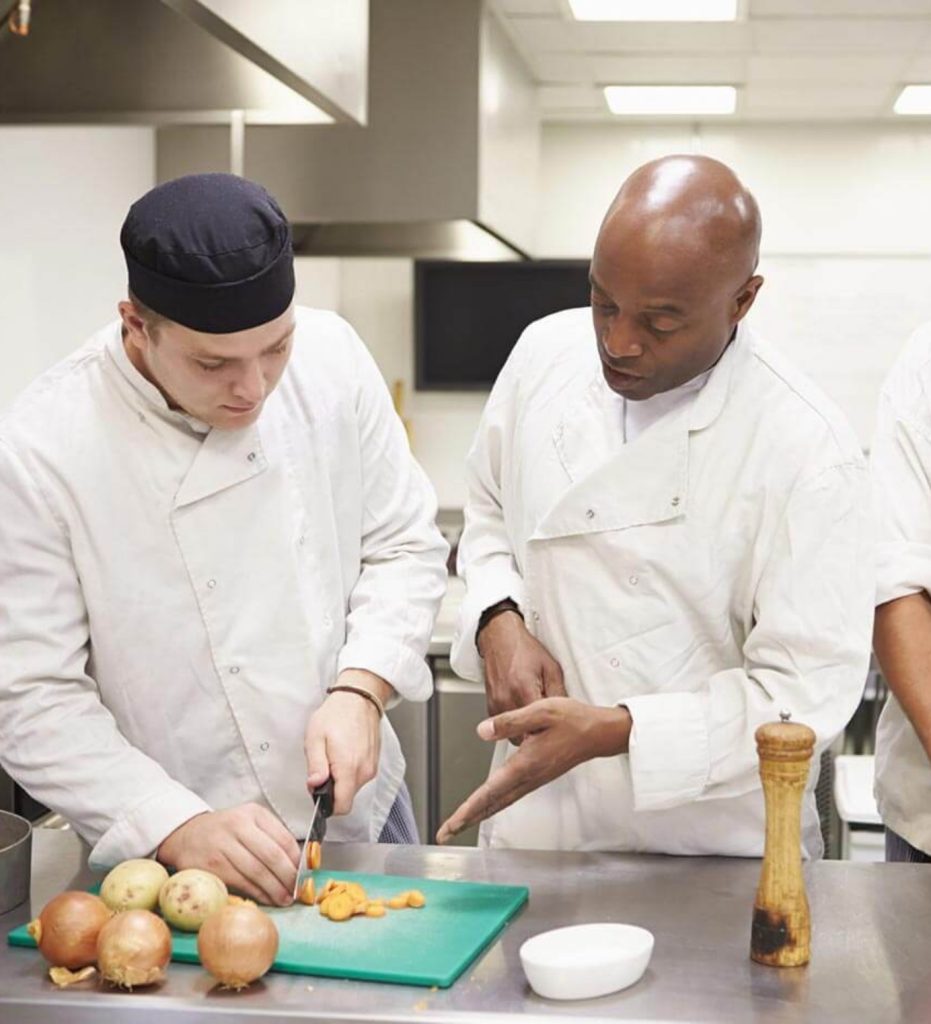 Chefxpertise Male Chef Showing How To Cut And Chop Carrots In Kitchen Scaled 1